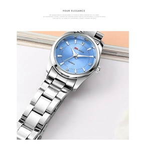 Detailed macro view of light blue sunburst dial with rhinestone markers and silver hands
