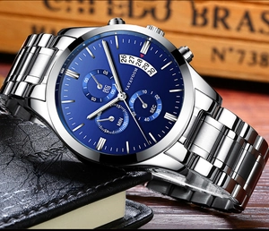 Detail of silver stainless steel chronograph watch with deep blue dial on leather