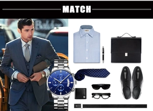 Detail of men's business quartz watch with blue dial and steel strap on suit model