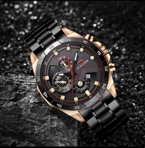 Close-up of black and rose gold chronograph watch with date display on rock surface
