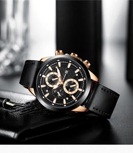 Detail view of business chronograph watch with black dial and leather strap