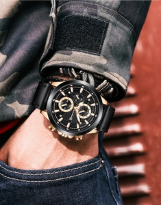 Close-up of men's leather watch with functional sub-dials and luminous date display