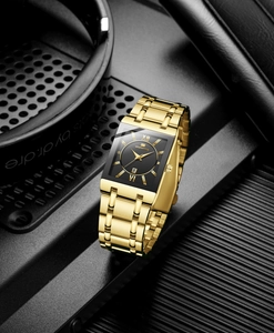 Detail view of the black square dial and golden Roman numerals of this business watch