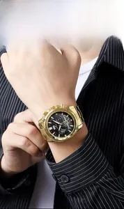 Detail of a men's gold stainless steel chronograph watch with black dial and sub-dials