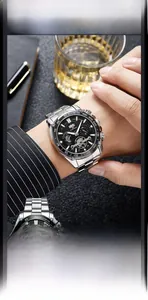 Close-up of a silver stainless steel men's watch with a black multifunctional dial