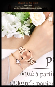 Detailed set of rose gold watch with clover bracelet and floral ring on white rose props