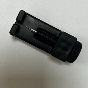 Black watch band removal tool with metal screw rod for link adjustment on white background