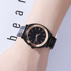 Minimalist black and rose gold stainless steel watch with a sleek metal link bracelet