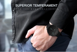 Close-up of a stylish black quartz sports watch with a sleek steel mesh band on wrist