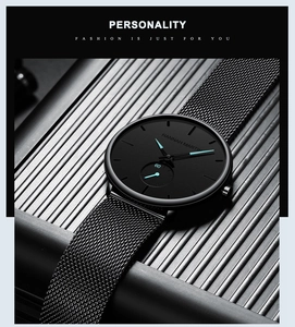 Detail shot of black minimalist watch dial with striking cyan blue hands and steel mesh strap