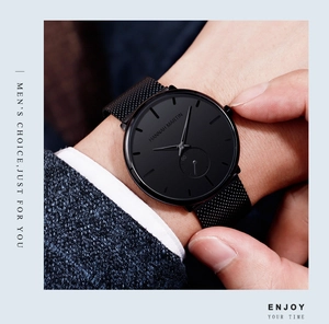 Detail view of the sleek black mesh strap and minimalist dial on a men's quartz watch