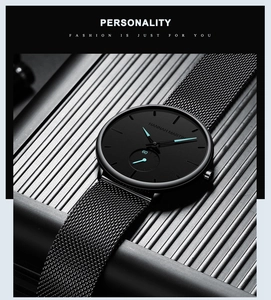 Detail of minimalist black steel mesh watch with blue luminous hands and small dial