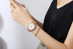 Close-up of Hannah Martin rose gold watch with colorful indices and matching bracelet