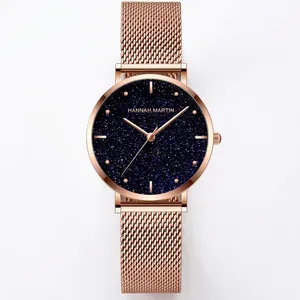 Montre Hannah Martin en or rose avec cadran ciel étoilé bleu et bracelet en maille