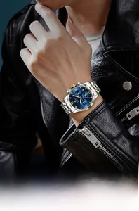 Close-up of business quartz watch with blue dial and two-tone steel strap on wrist