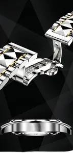 Detail of two-tone stainless steel watch band with butterfly clasp on black background