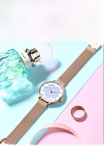 Détail d'une montre en maille or rose avec cadran floral violet sur un fond élégant