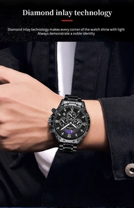 Detail of a black stainless steel watch with moon phase and Roman numeral dial on wrist