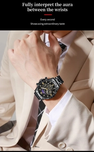 Close-up of black steel chronograph watch with gold roman numerals and moon phase