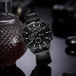 Detailed close-up of VAVA VOOM black chronograph watch with leather strap on reflective surface