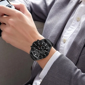Detail of a men's business chronograph watch with black leather strap and calendar