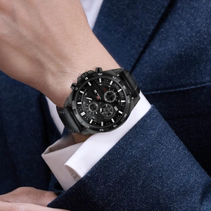 Close-up of WWOOR black multi-function chronograph watch worn with a navy suit