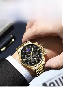 Close-up of golden men's watch with black multifunctional dial worn on a wrist