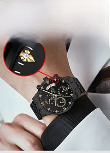 Detailed macro view of black stainless steel watch dial with gold markers and date window