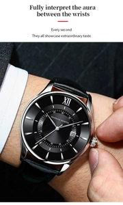 Detail of a business quartz watch with date display on a black dial and leather strap