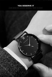 Close-up of minimalist black business watch with mesh strap and Roman numeral XII