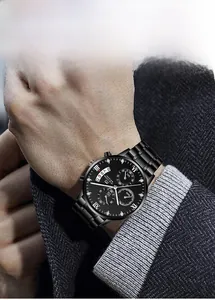 Detailed shot of black quartz business watch featuring a Roman numeral dial on a male wrist