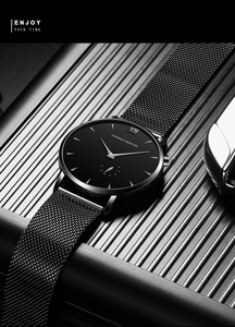 Close-up of minimalist black business watch with stainless steel mesh band and matte case