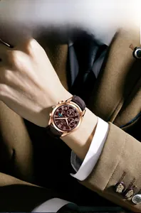 Macro detail of the multifunctional quartz watch with rose gold case and brown leather strap