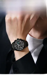 Detail of luxury men's chronograph watch with black leather strap and Roman numerals dial