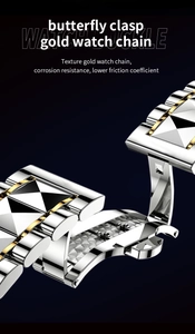 Close-up of stainless steel butterfly clasp on gold and silver two-tone watch band