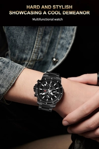 Detail of a black stainless steel multifunctional business watch worn with denim style