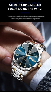 Detail showing the stereoscopic diamond-cut mirror and blue dial on a gold steel watch