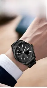 Macro shot of a black minimalist quartz watch featuring a steel strap and calendar display