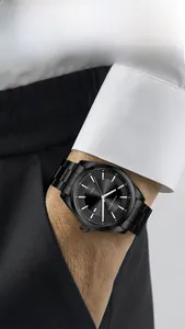 Detail shot of a black stainless steel business watch with date window on a male wrist