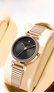 Macro shot of elegant rose gold watch with black dial and crystal on a watch pillow