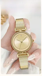 Detail of elegant gold mesh watch band with polished finish and secure clasp closure