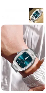 Detail of silver stainless steel rectangular watch featuring a teal dial and dual calendar