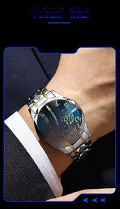 Detail of a men's business watch with a blue dial, diamond-cut bezel, and metal strap