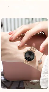 Close-up of elegant rose gold mesh watch with a minimalist black dial on female wrist
