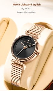 Detail of rose gold elastic expansion strap and black sunburst dial with single diamond