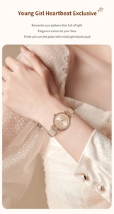 Close-up of elegant rose gold women watch with sunray dial and mesh metal strap