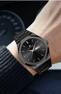 Detail of all-black steel watch dial featuring day-date display on male model wrist