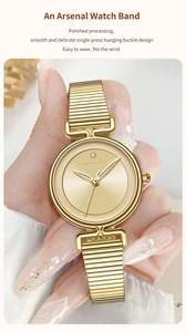 Macro shot of minimalist gold mesh strap watch with a single diamond dial on female wrist