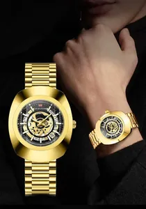Detail of gold skeleton watch featuring diamond-cut glass and stainless steel band