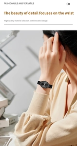 Detail showing the black square dial with silver markers and metal link strap on wrist